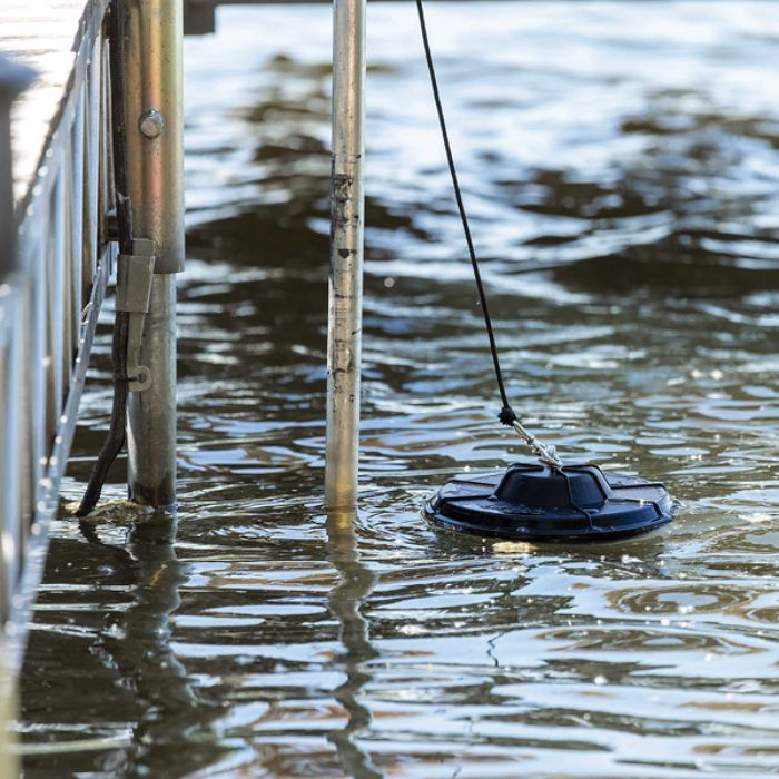 Shallow water kit at the surface of water attached to dock via a cable.