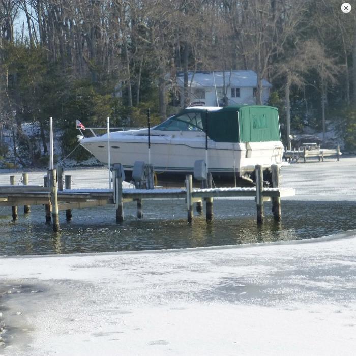 Kasco 3400D 3/4HP 120V Pond De-Icer with a Boat and Trees Background