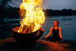 Namaste 36" Steel Fire Pit by Fire Pit Art with Big Fire and a Woman Sitting 