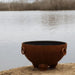 Nepal 41" Steel Fire Pit by Fire Pit Art with a Lake Background