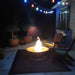 Saturn Steel Fire Pit with Lid by Fire Pit Art in Outside the House with Two Chairs