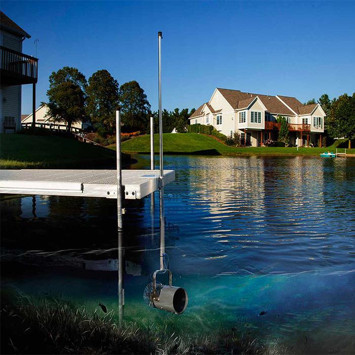 Image of the Scott Aerator Dock Mount Aquasweep Muck Blaster Under the Water with Houses and a Dock